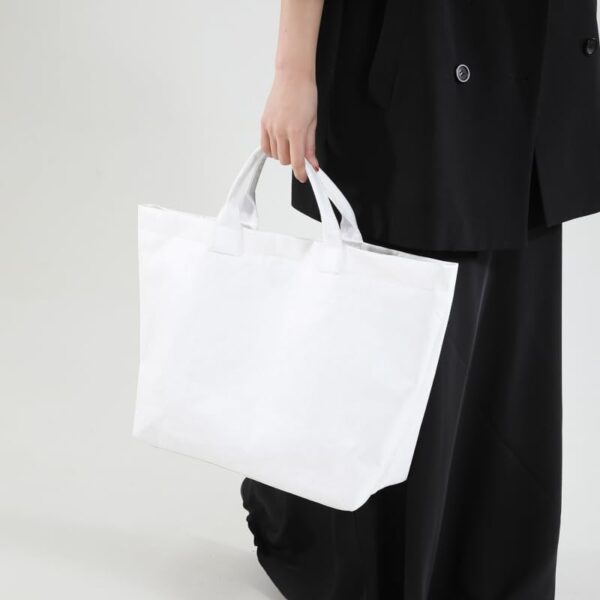 White DuPont Paper Tote Bag Manufacturer Guide: MOQ 500, 20–25 Days Lead Time & Global Delivery for Bulk Travel Bag Orders 3 white tote bag handheld side view 03